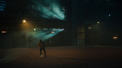 a man standing in the dark with a soccer ball