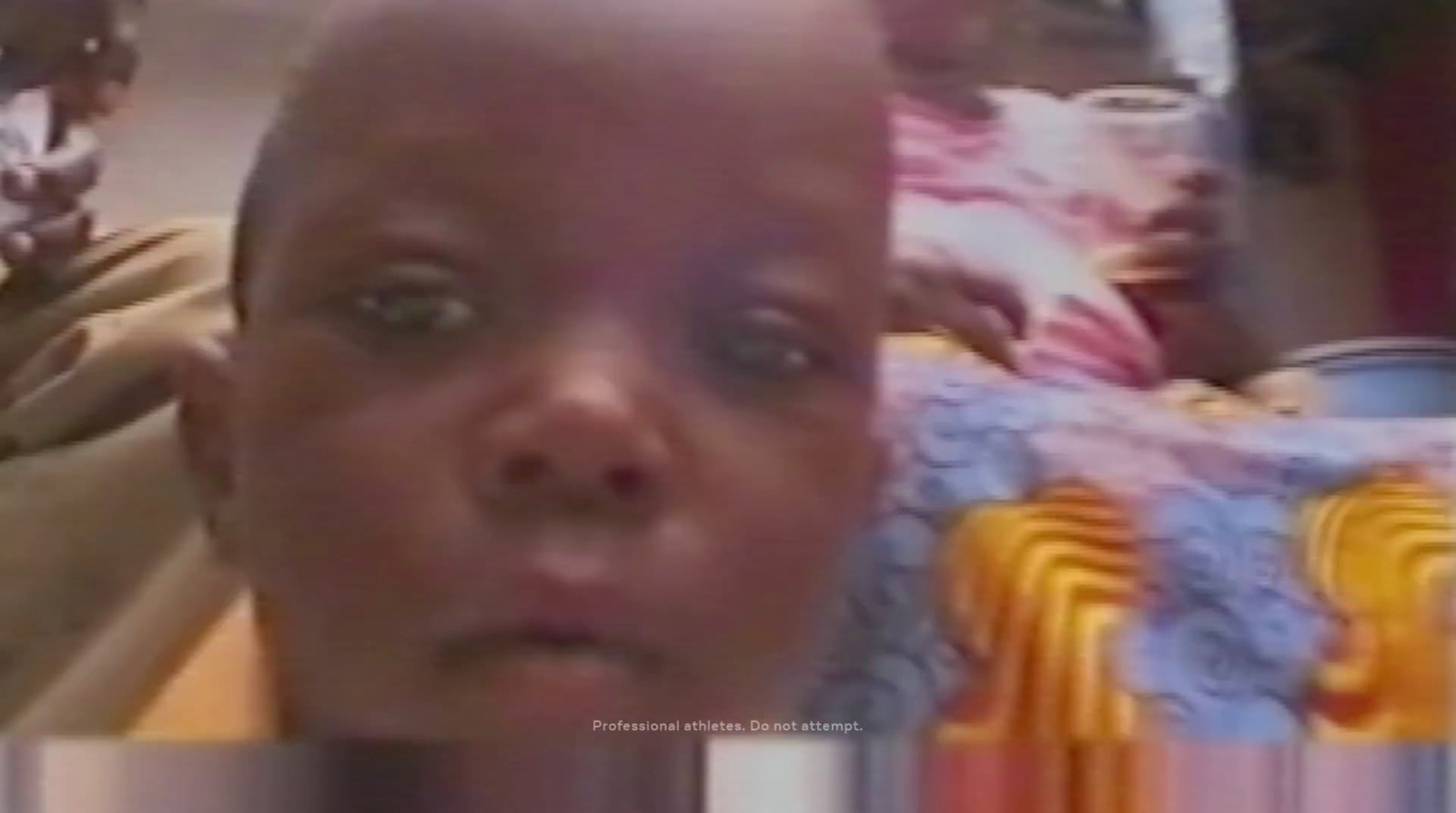 a man with a bald head is looking at the camera