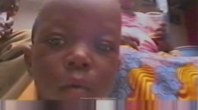 a man with a bald head is looking at the camera