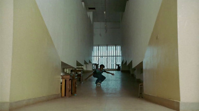 a person riding a skateboard down a hallway