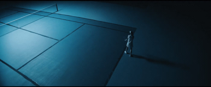 a tennis court in the middle of a dark room