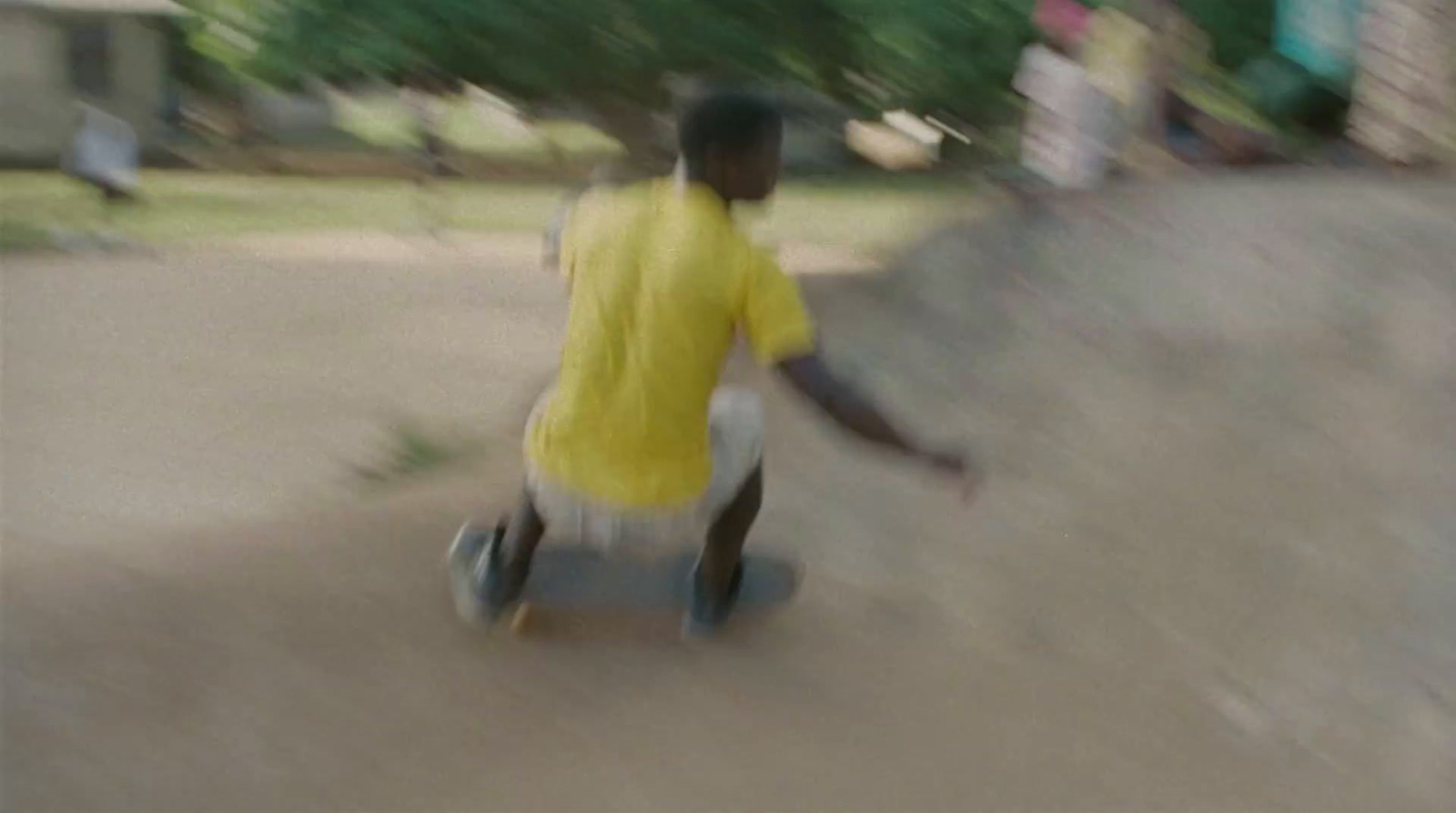 a man riding a skateboard down a sidewalk