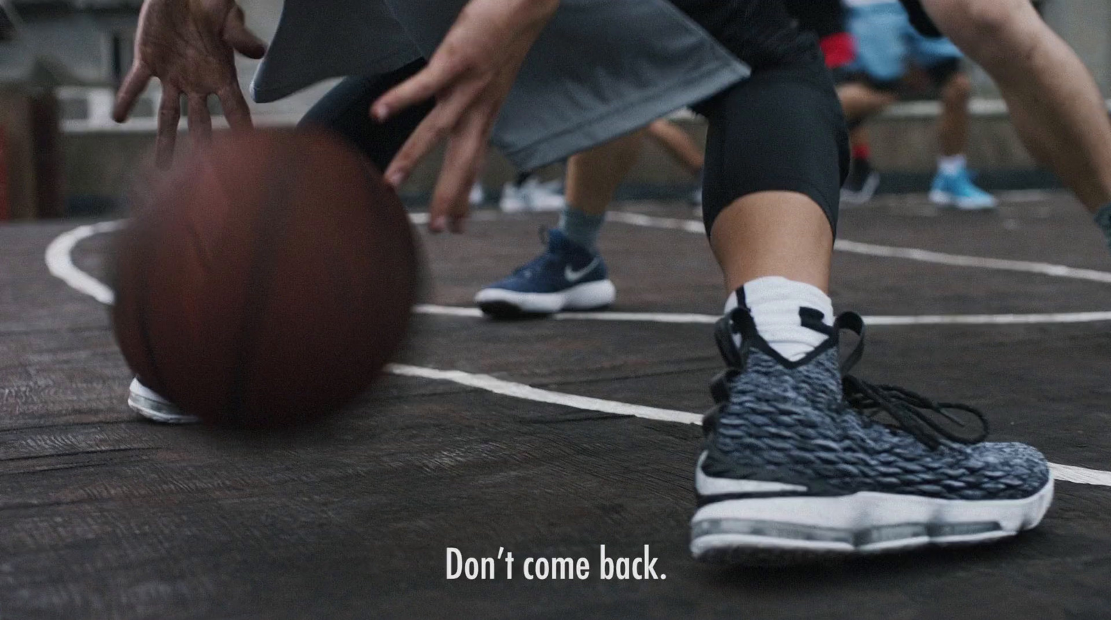 a basketball player dribbles the ball on the court