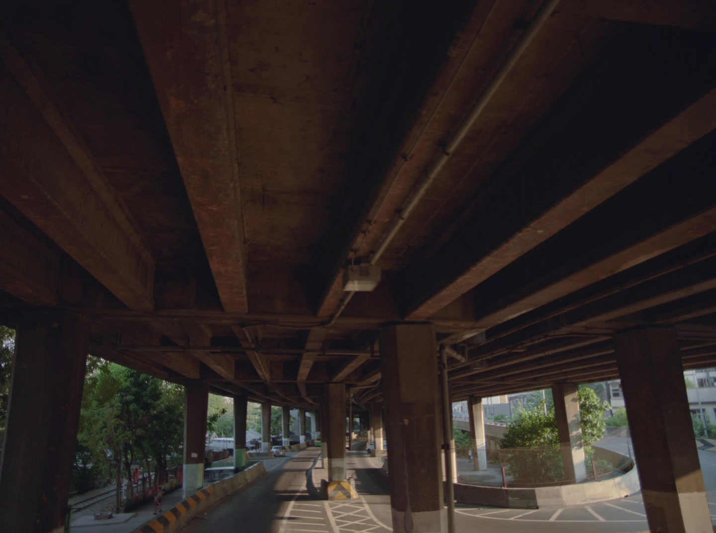 a view of a street from under a bridge