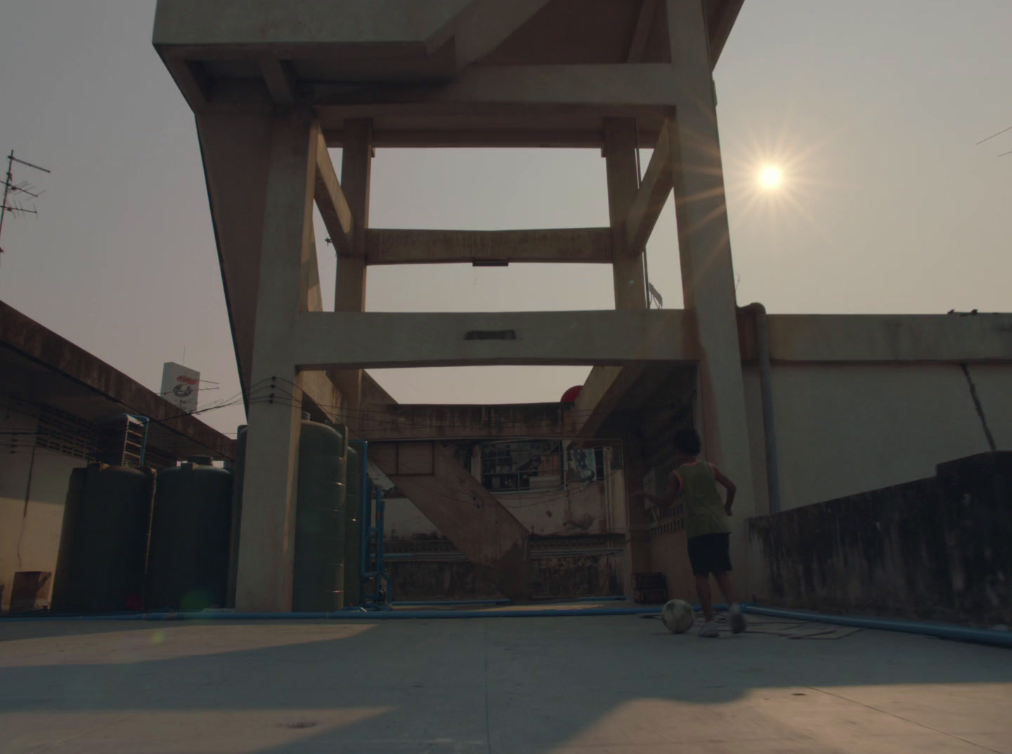 a man standing under a tall wooden structure