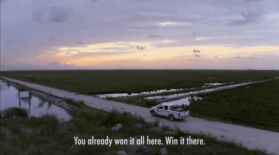 a white van driving down a road next to a river