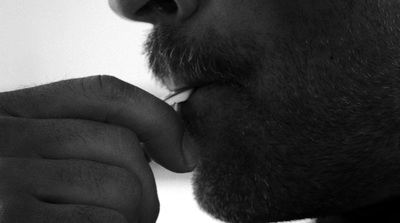 a man is brushing his teeth with a toothbrush