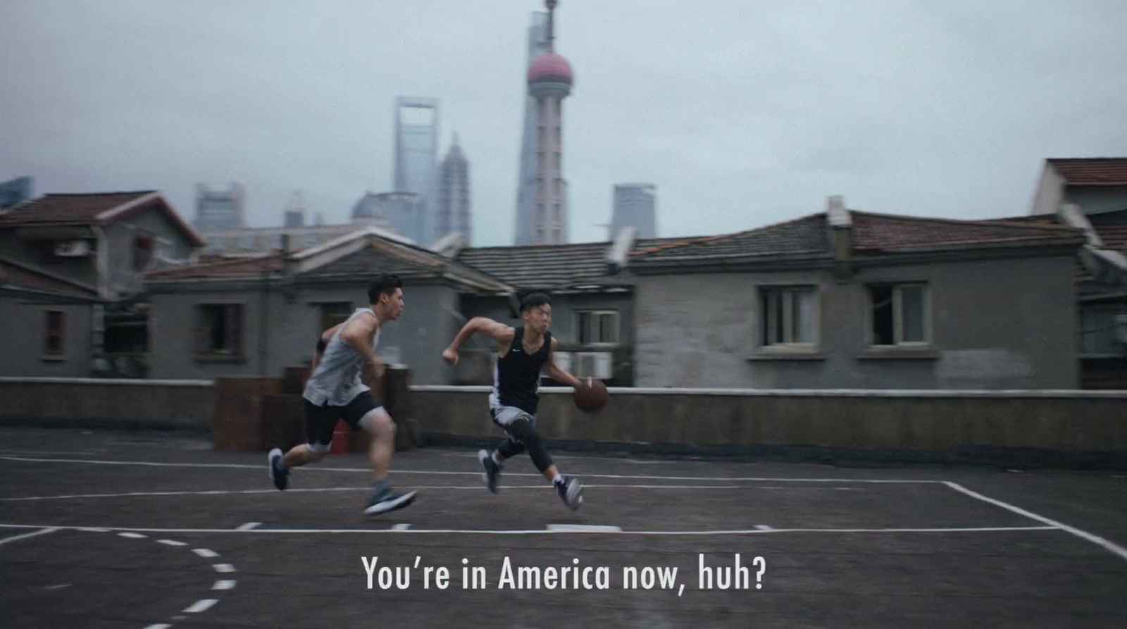 a couple of men running across a basketball court