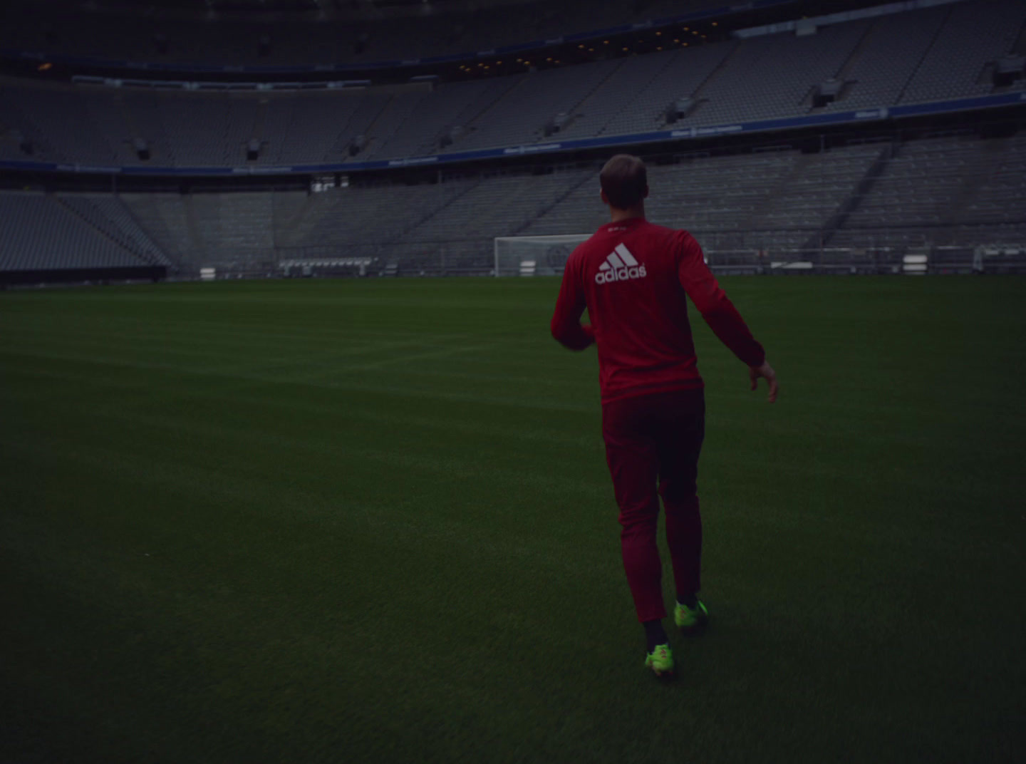 a man in a red shirt is on a soccer field