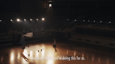 a group of people playing basketball on a basketball court