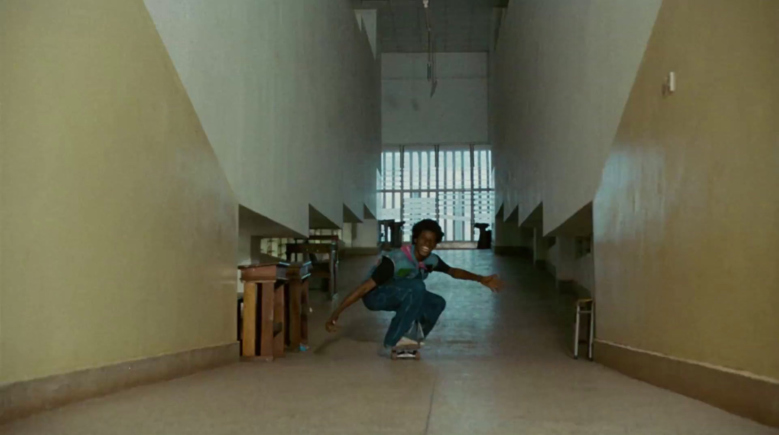 a person kneeling down in a long hallway