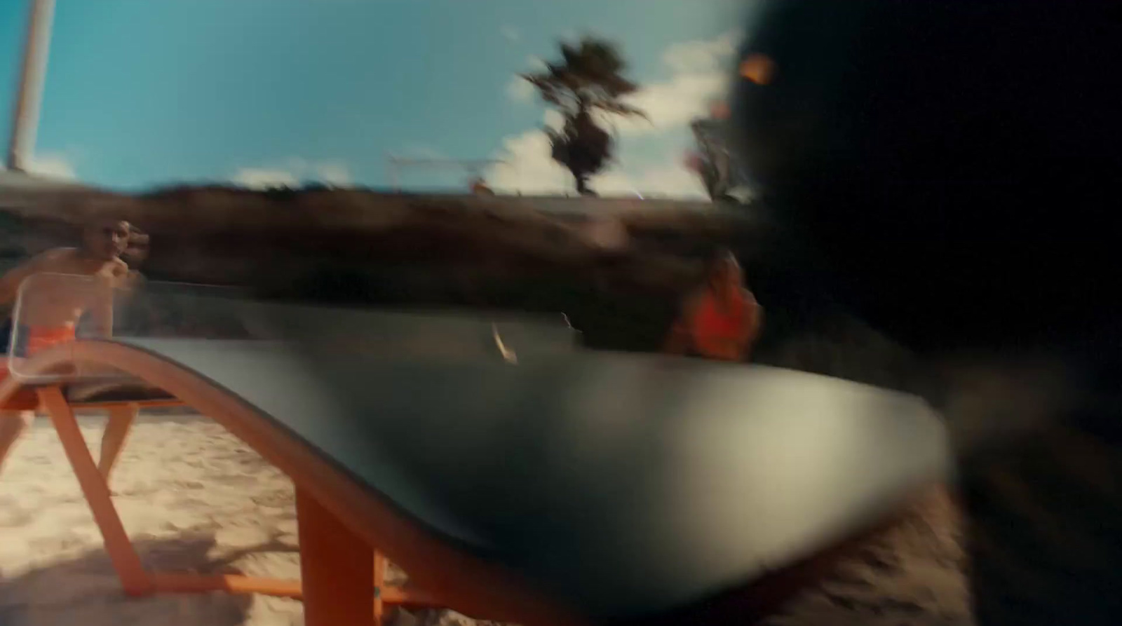 a blurry photo of a beach chair and a surfboard