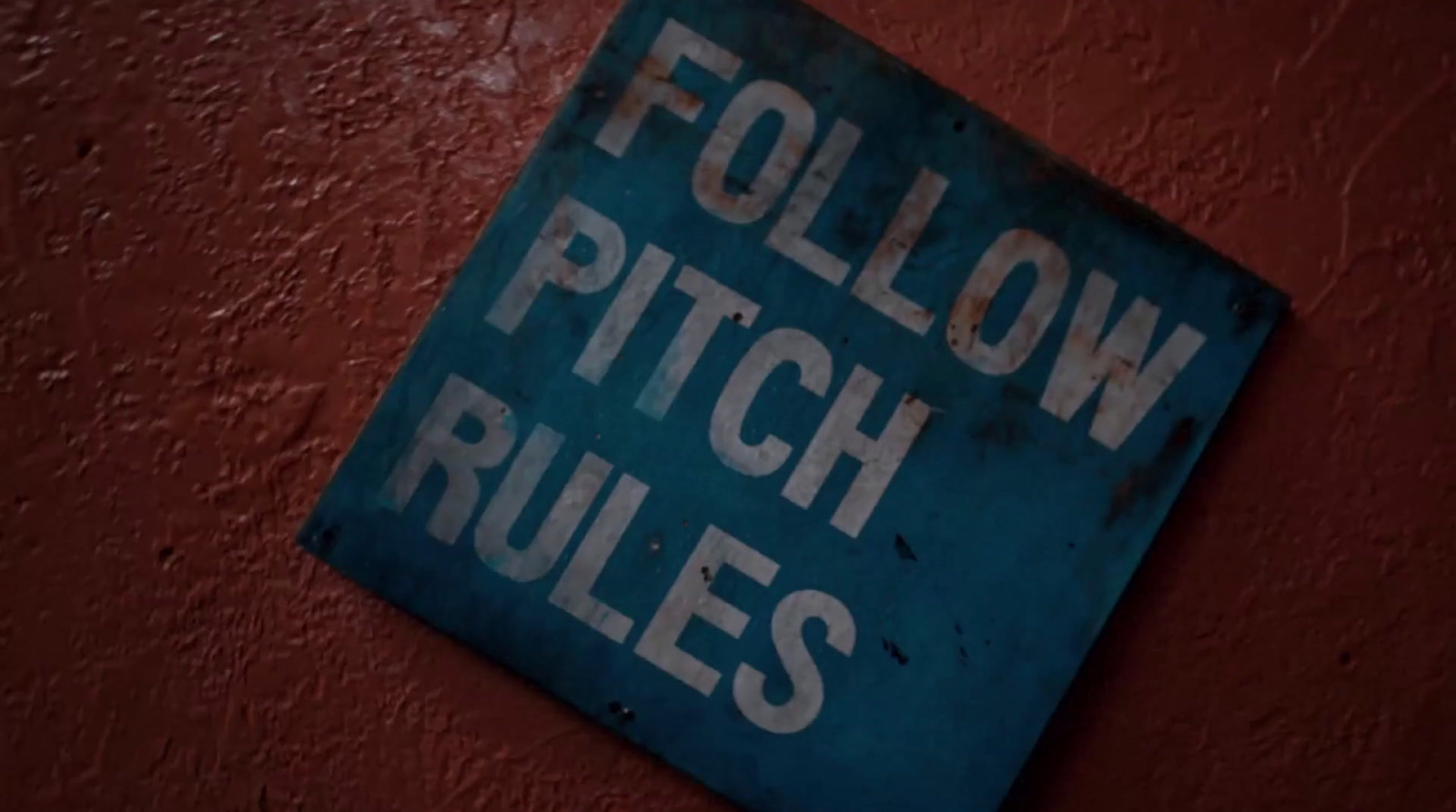 a blue sign that reads follow pitch rules