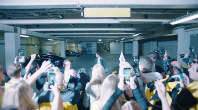 a group of people taking pictures in a parking garage