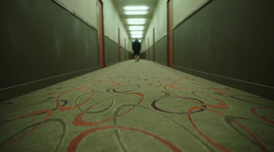 a man is walking down a long hallway