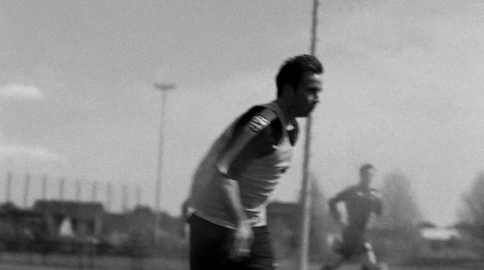 a black and white photo of a man playing soccer