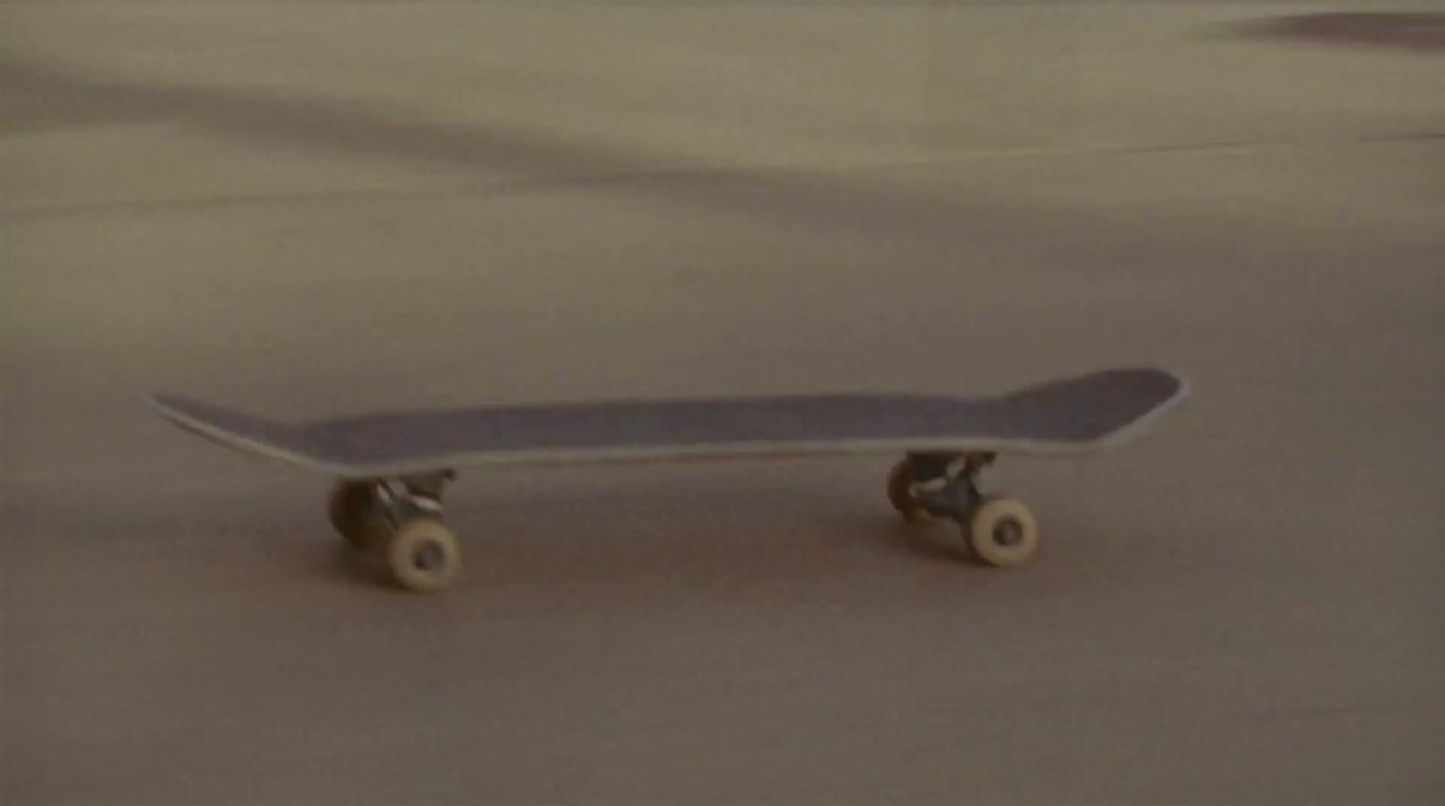 a skateboard sitting on top of a cement floor