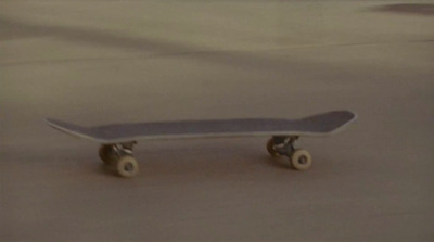 a skateboard sitting on top of a cement floor