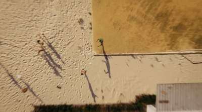 an aerial view of a beach and a building