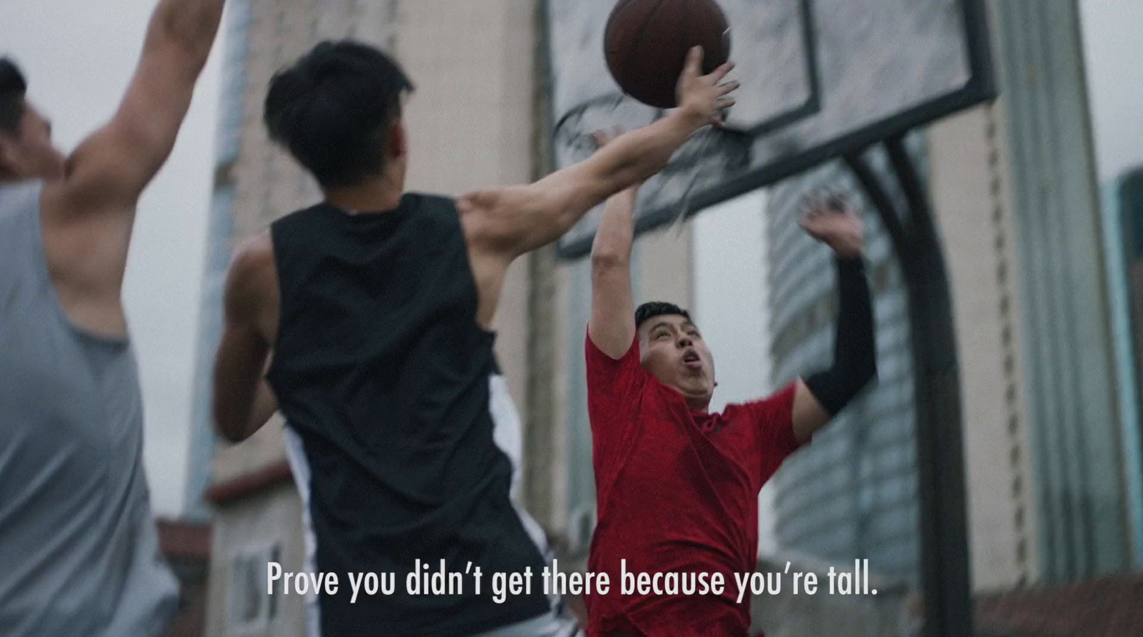 a group of young men playing a game of basketball