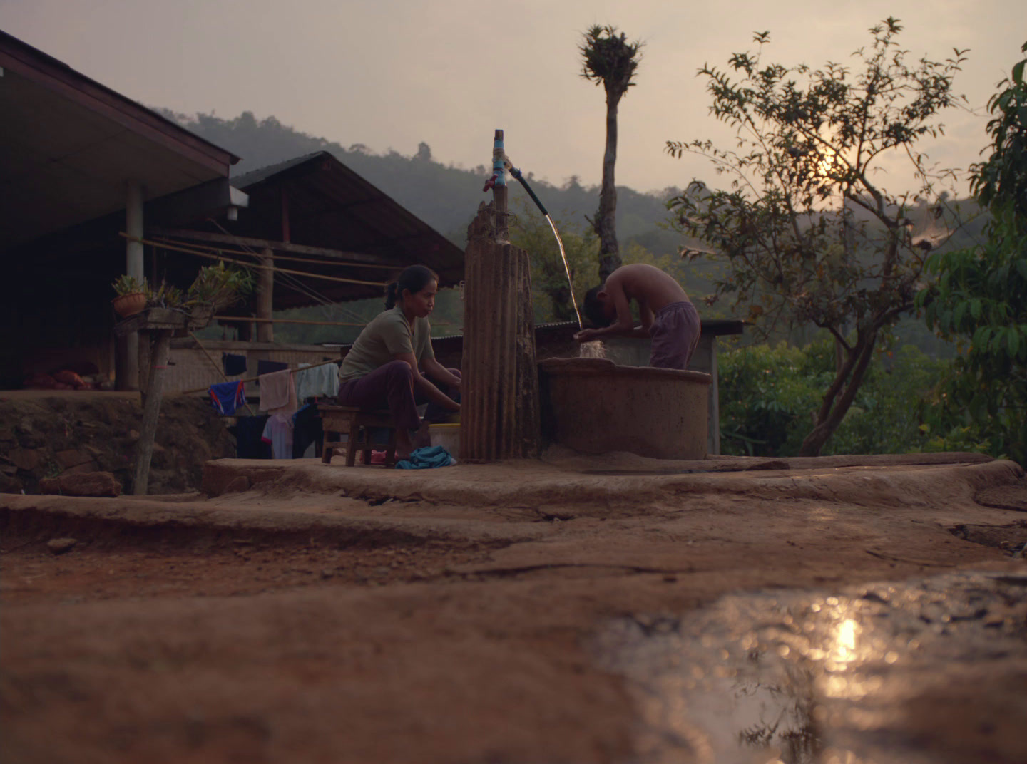 a group of people sitting around a water fountain