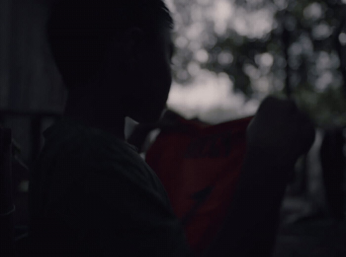 a silhouette of a man holding a red frisbee