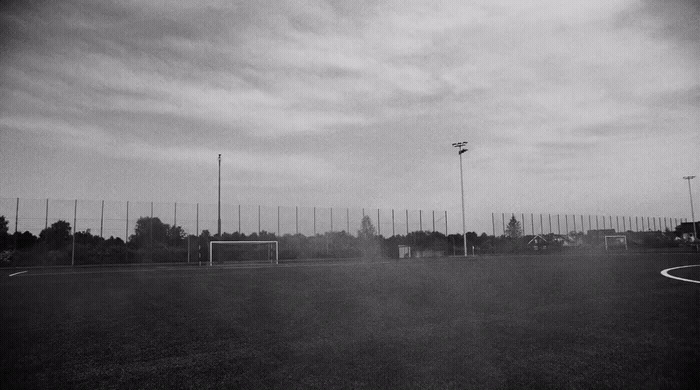 a black and white photo of a soccer field