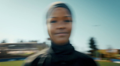 a blurry photo of a woman in a black jacket