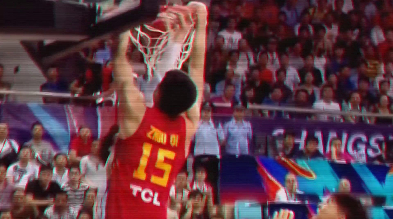 a man dunking a basketball in front of a crowd