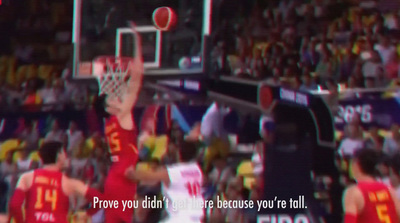 a basketball player dunking a basketball in front of a crowd