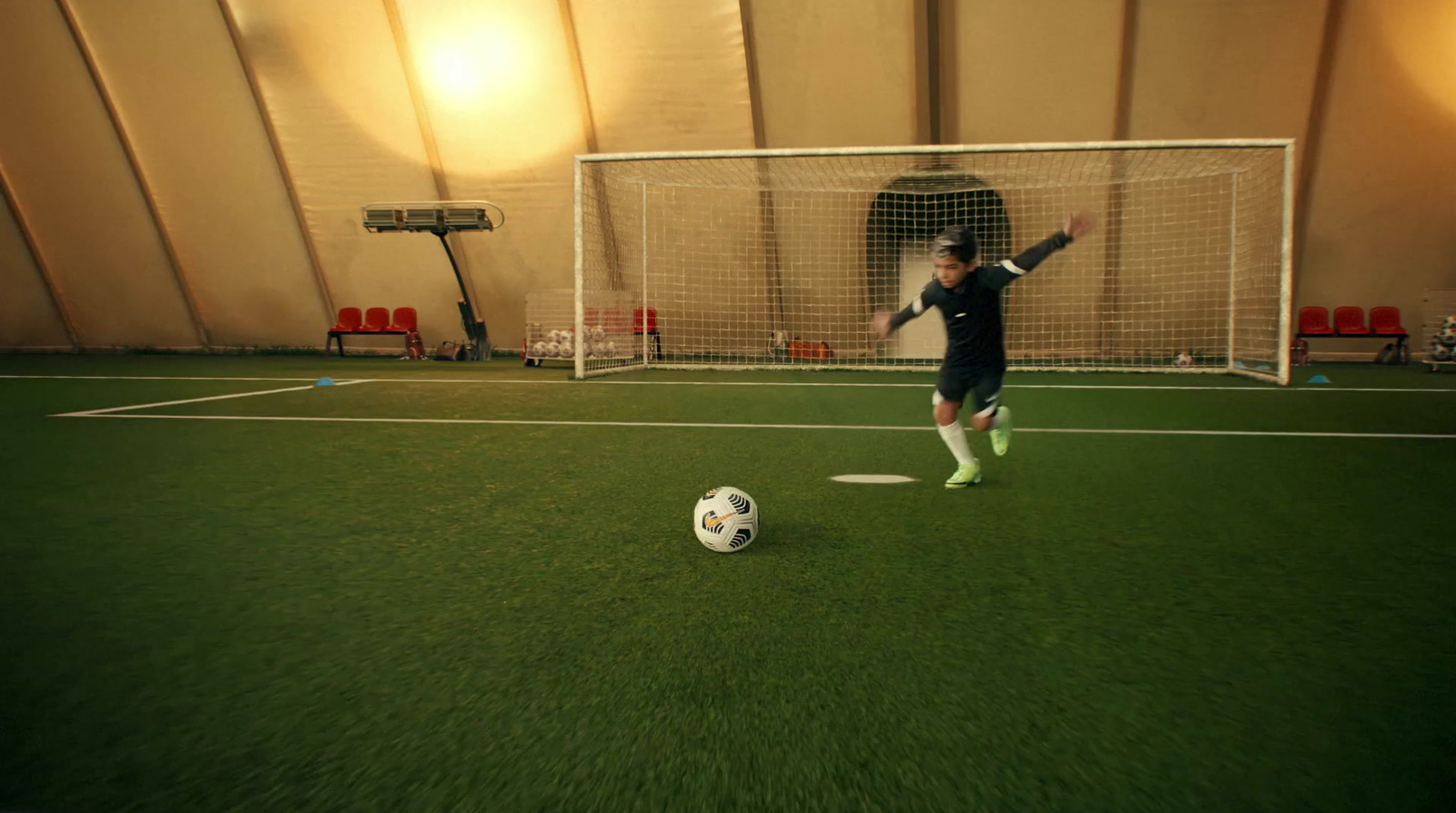 a man standing on top of a soccer field next to a soccer ball