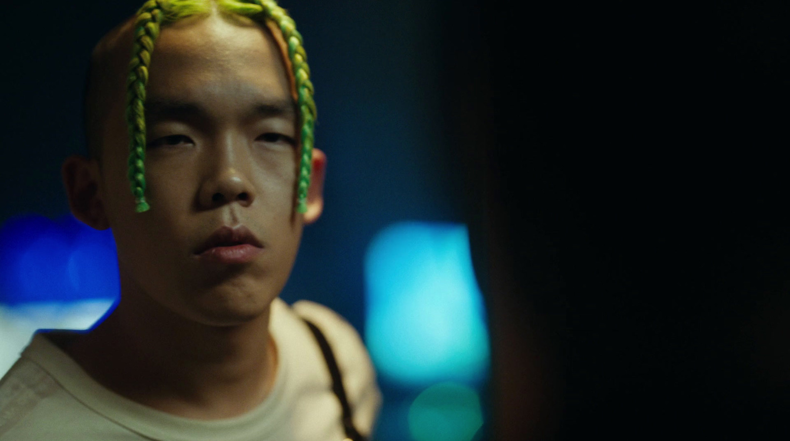 a man with a green braid on his head