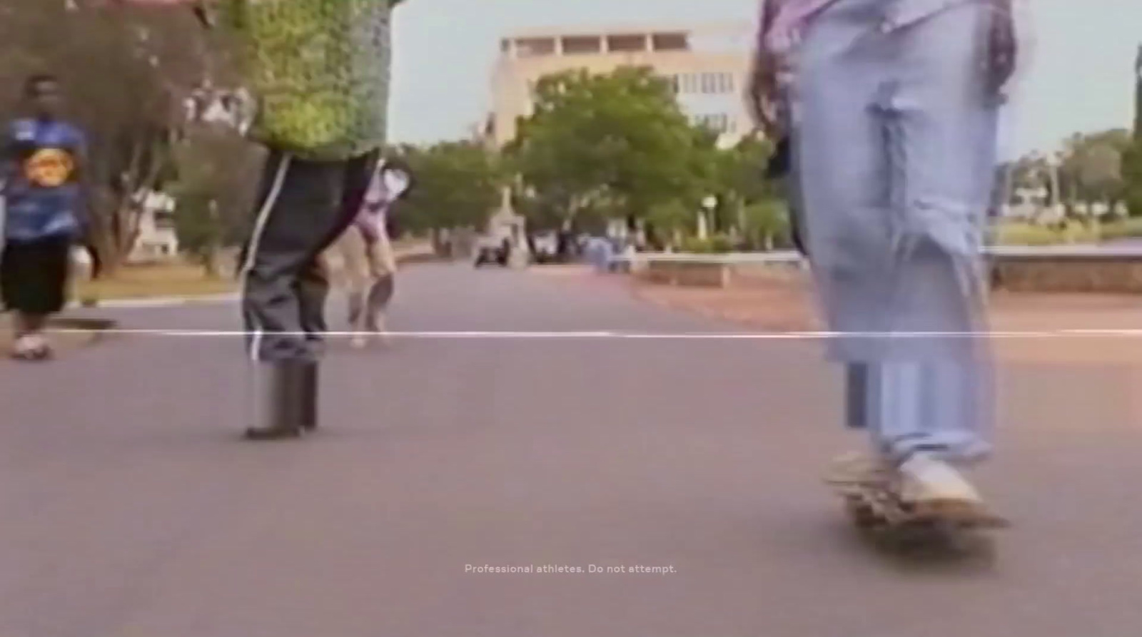 a group of people riding skateboards down a street