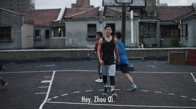 a group of young men playing a game of basketball