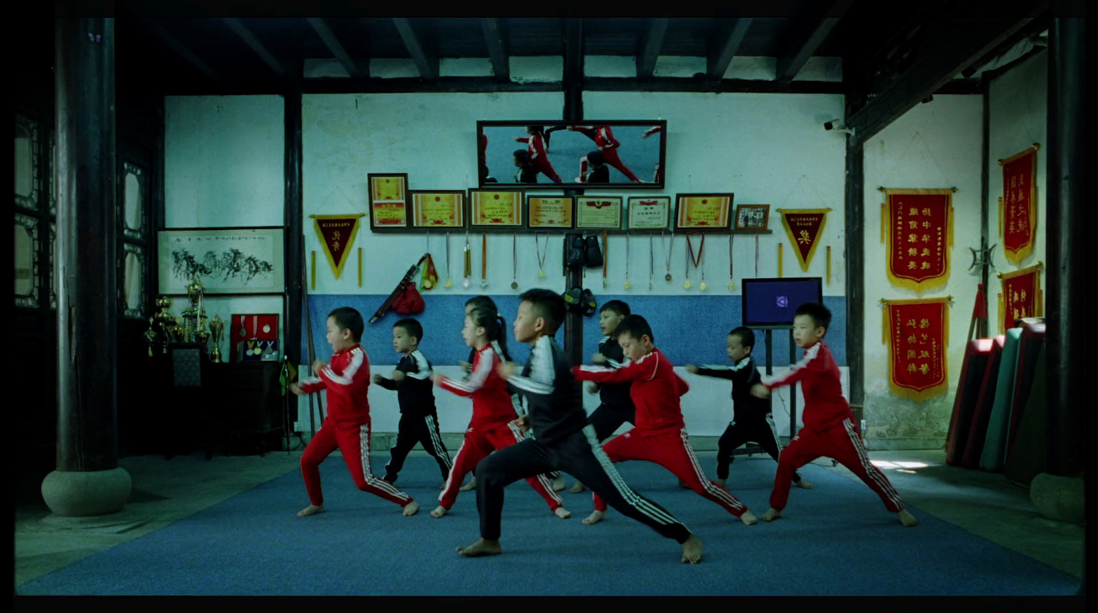 a group of young children practicing martial moves