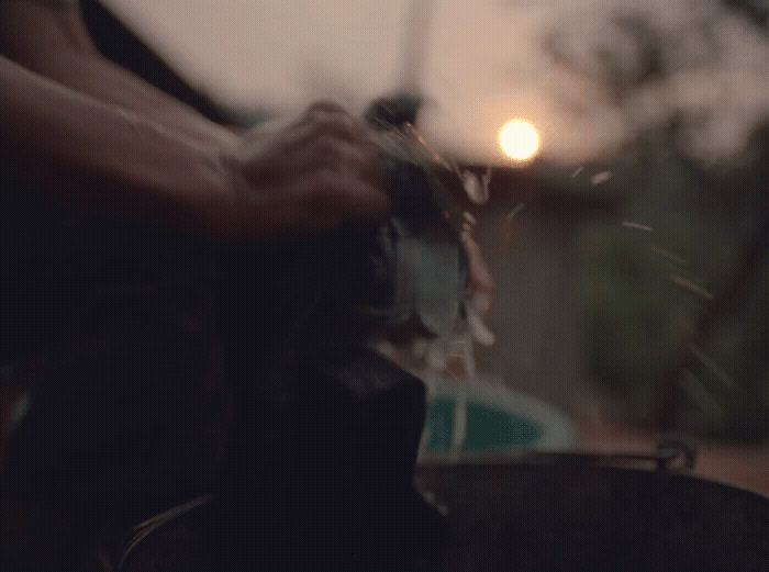 a blurry image of a person pouring something into a bucket