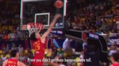 a basketball player dunking a basketball in front of a crowd