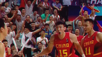 a group of men standing on top of a basketball court