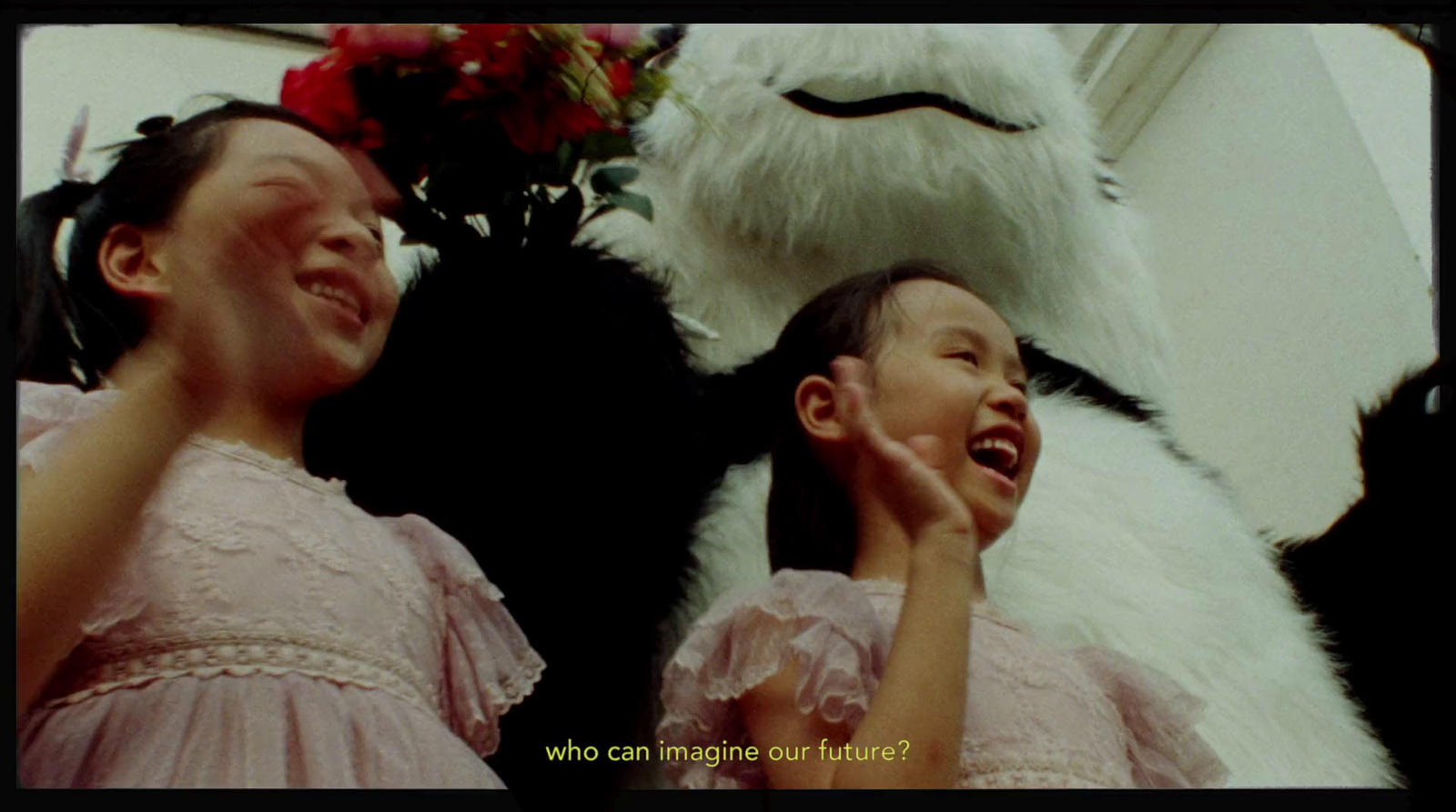 two young girls standing next to a large stuffed animal