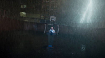 a man standing at a podium in the rain