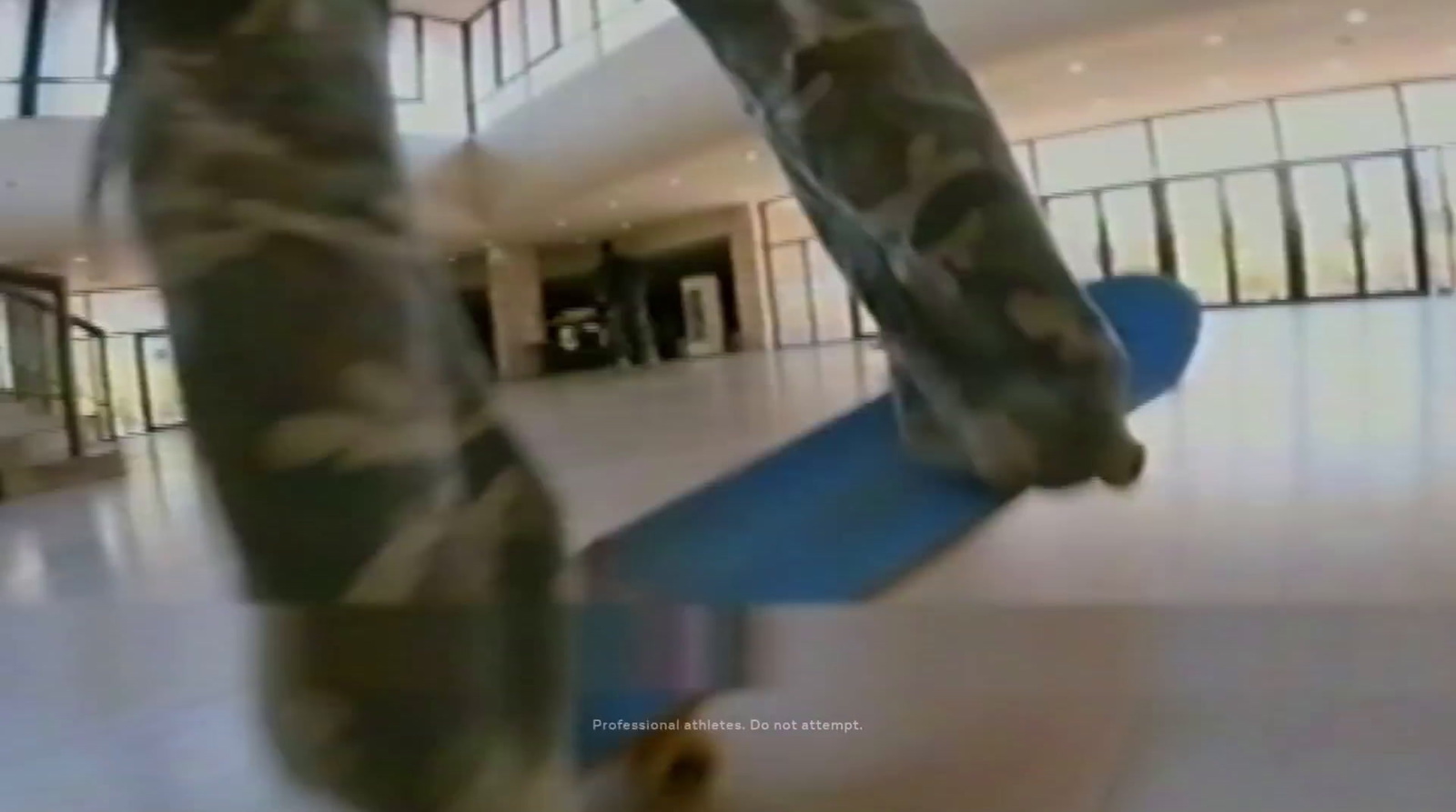 a man riding a blue skateboard down a hallway