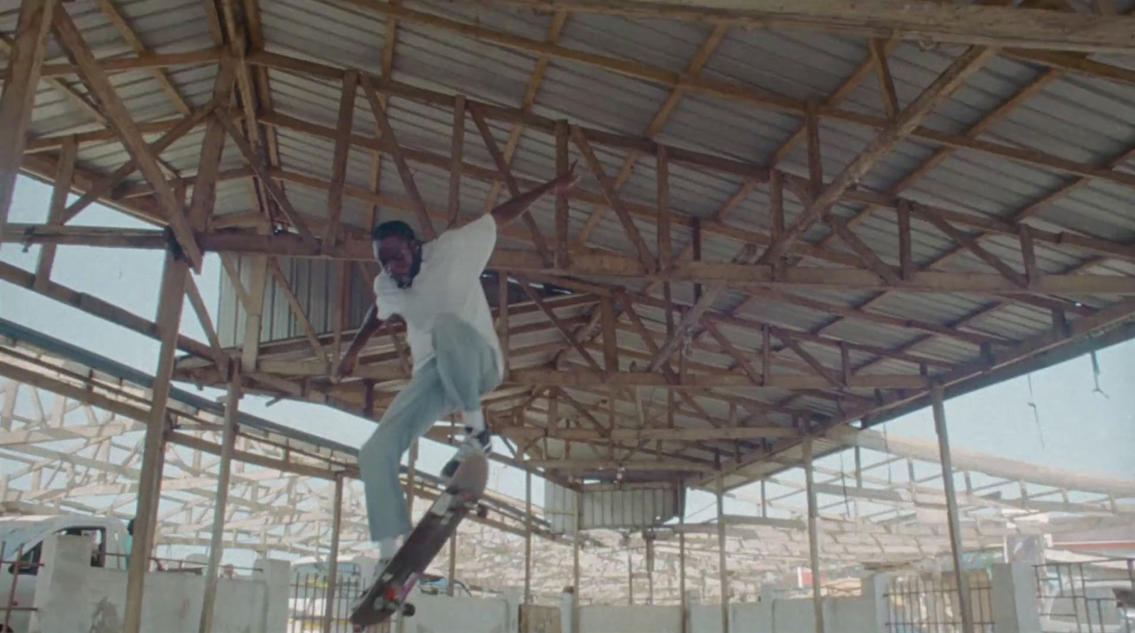 a man riding a skateboard up the side of a wooden structure