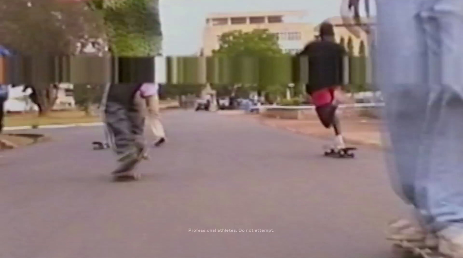 a group of people riding skateboards down a street