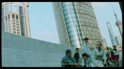 a group of people walking down a street next to tall buildings