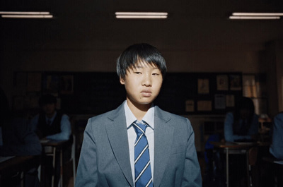 a man in a suit and tie standing in a room