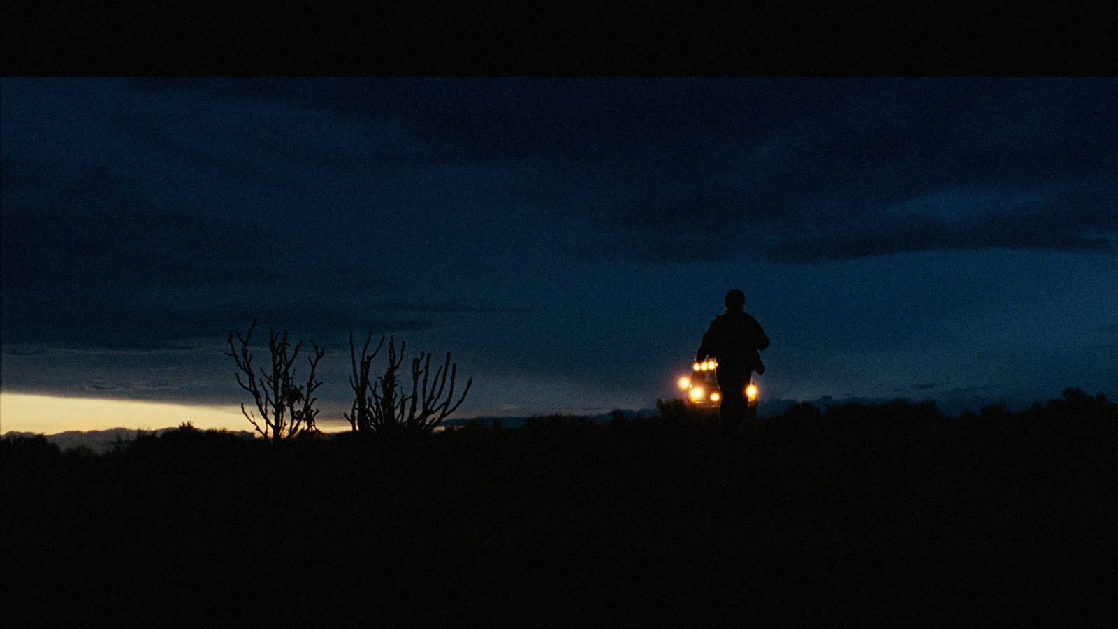 a person riding a bike in the dark