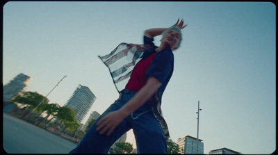 a man in a red, white and blue shirt is holding a frisbee