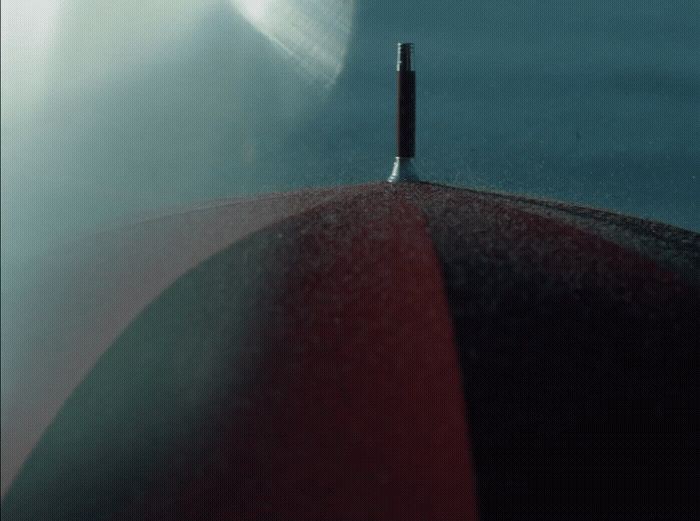 a close up of a red umbrella with a sky background