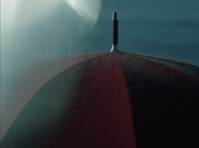 a close up of a red umbrella with a sky background