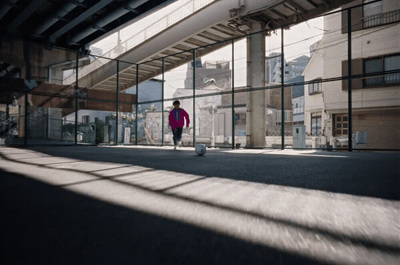 a person walking down a street with a skateboard